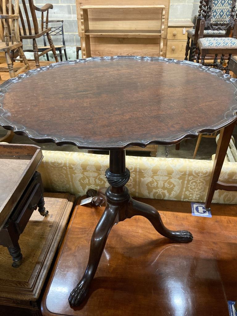 A George III style mahogany circular tripod table (later carved), 73cm diameter, height 70cm